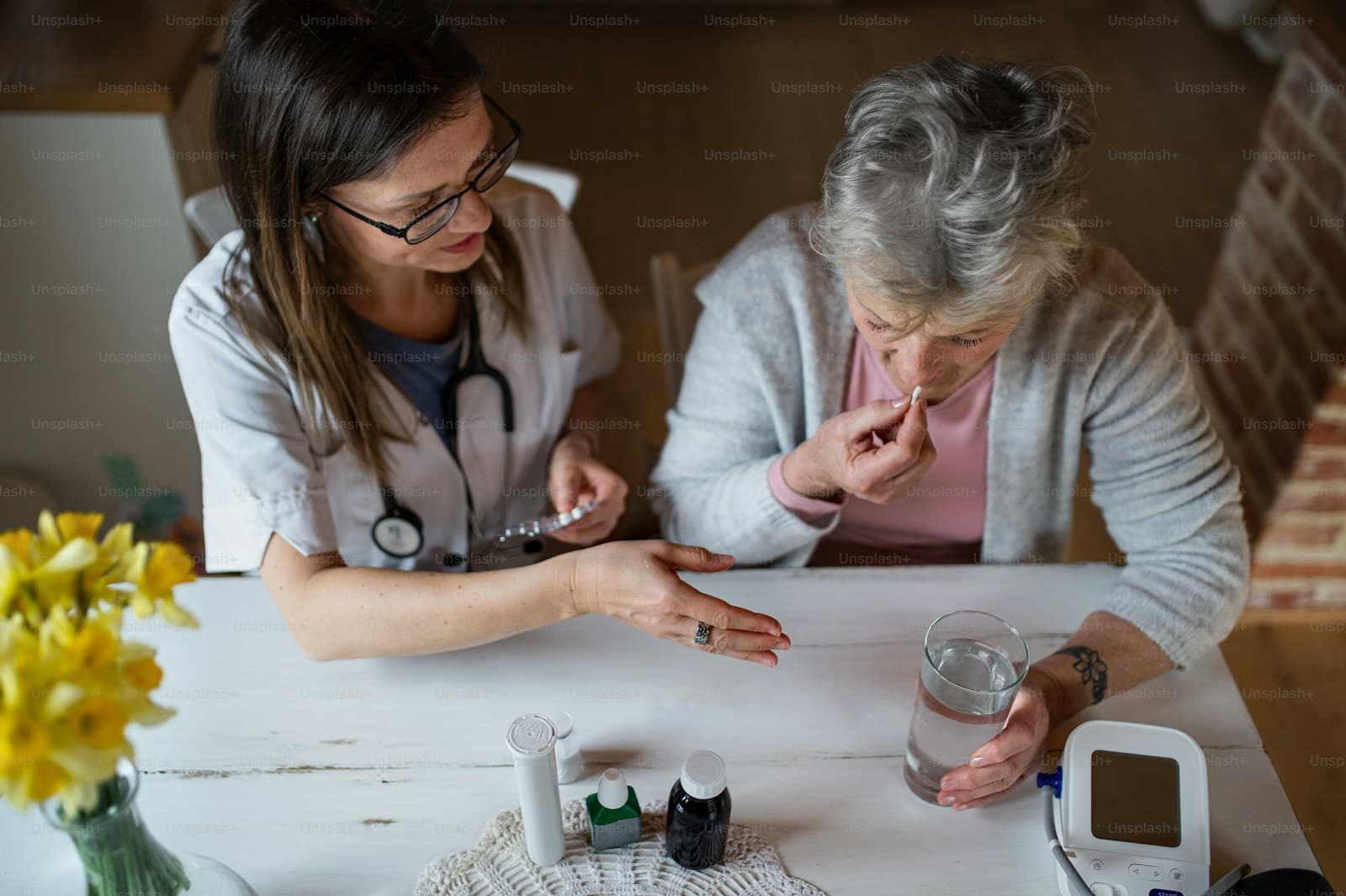 A healthcare worker explaining care details to a senior woman at home