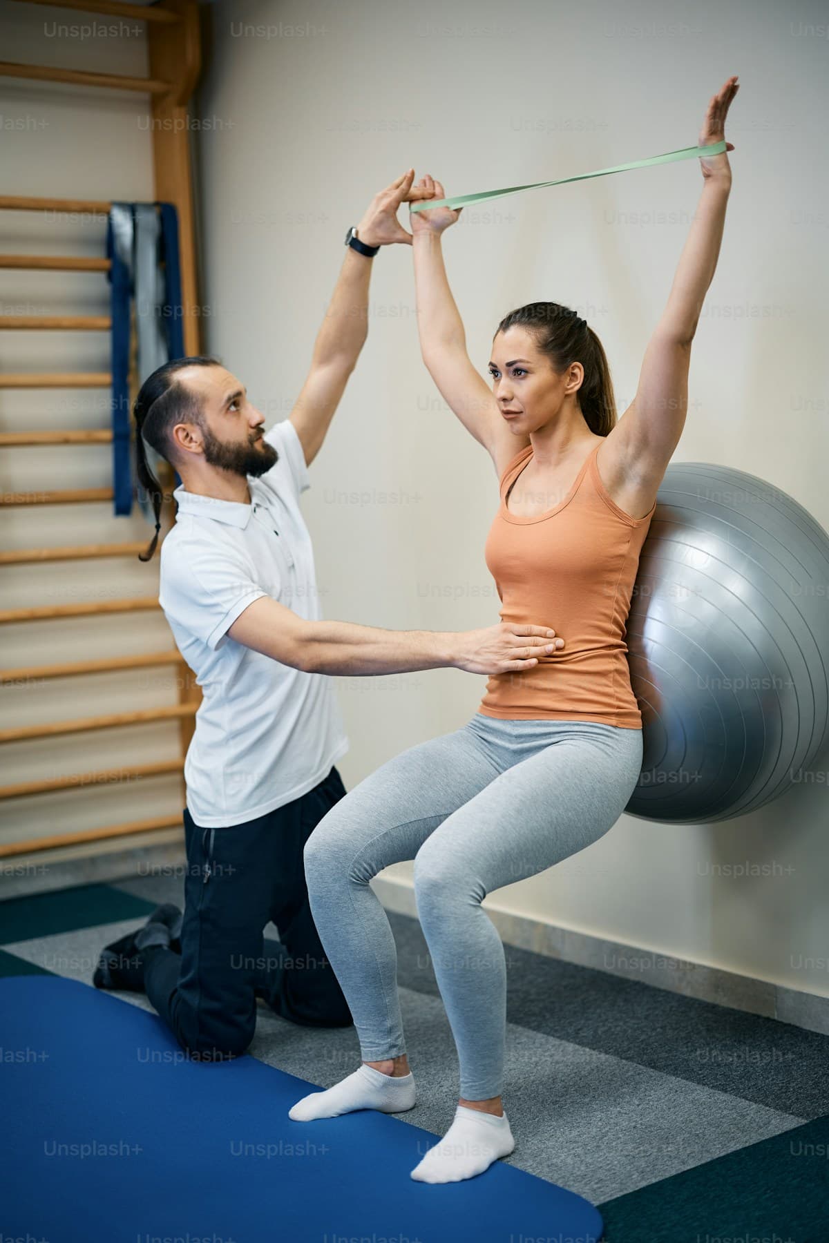 A physiotherapist helping a patient with gentle recovery exercise